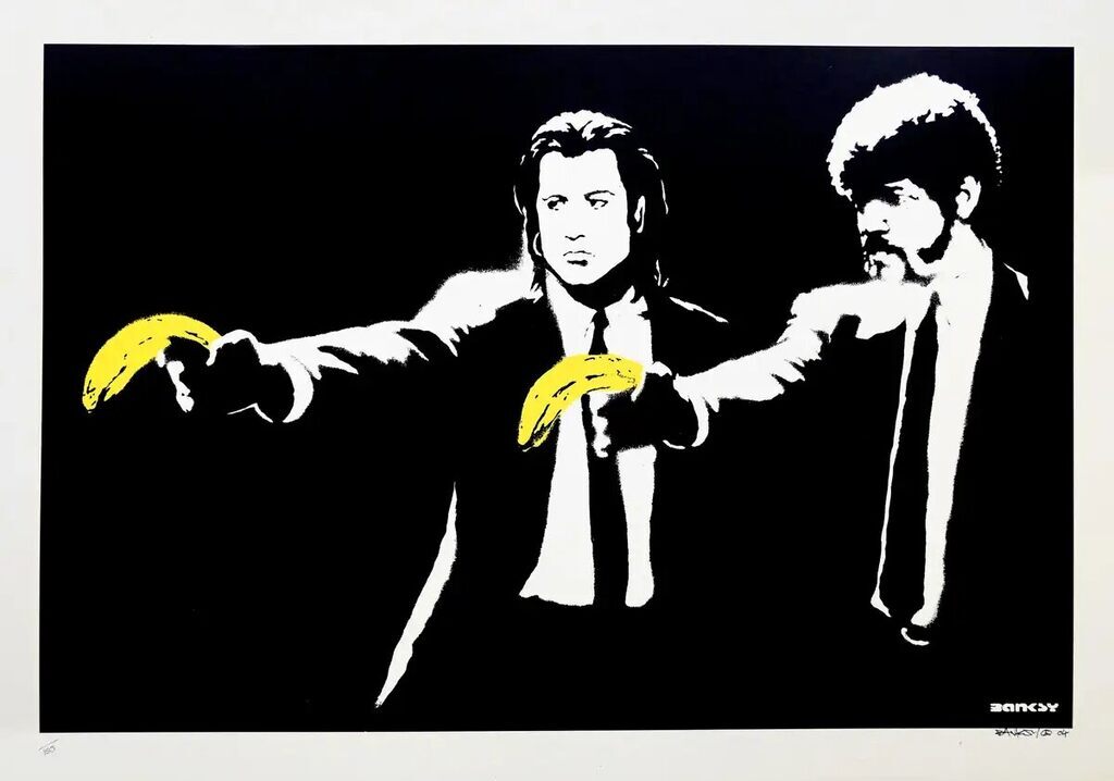 Two black-and-white suited men point bright yellow bananas against a black background.