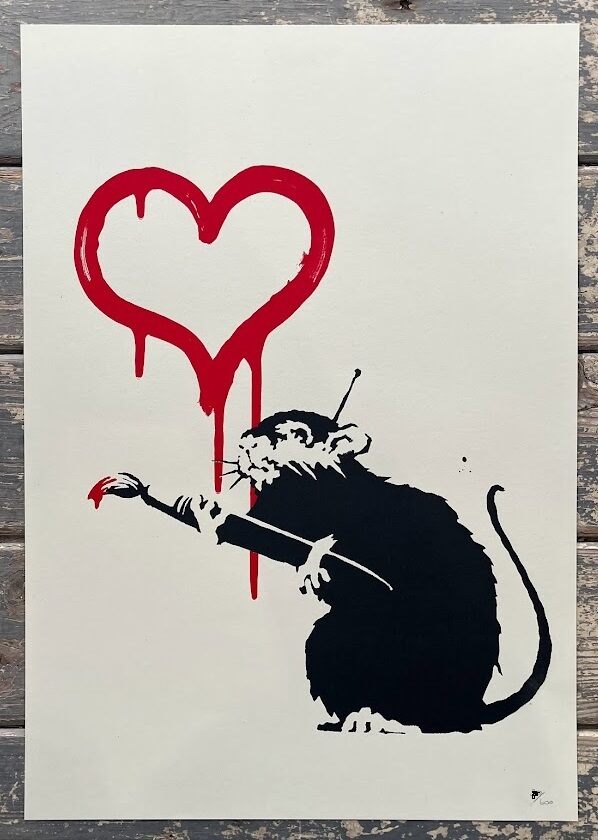 A black rat with white face markings holds a long brush tipped with red paint; above it, a red outlined heart drips downward on an off-white background.