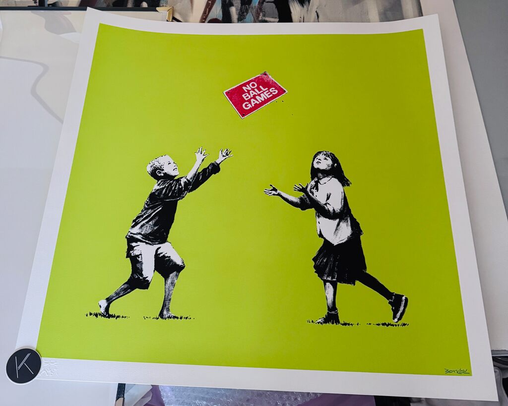 Two children toss a red No Ball Games sign against a bright lime-green background.