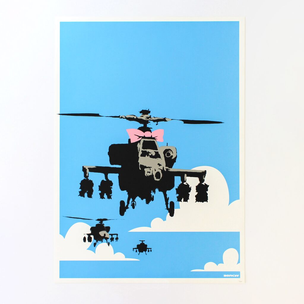 Pink-bowed black helicopters in a blue sky above white clouds.