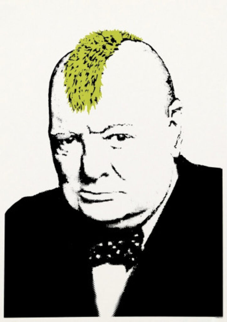 A black-and-white portrait of a bald man in a dark suit and bow tie, with a bright green patch of spiky hair on top of his head.