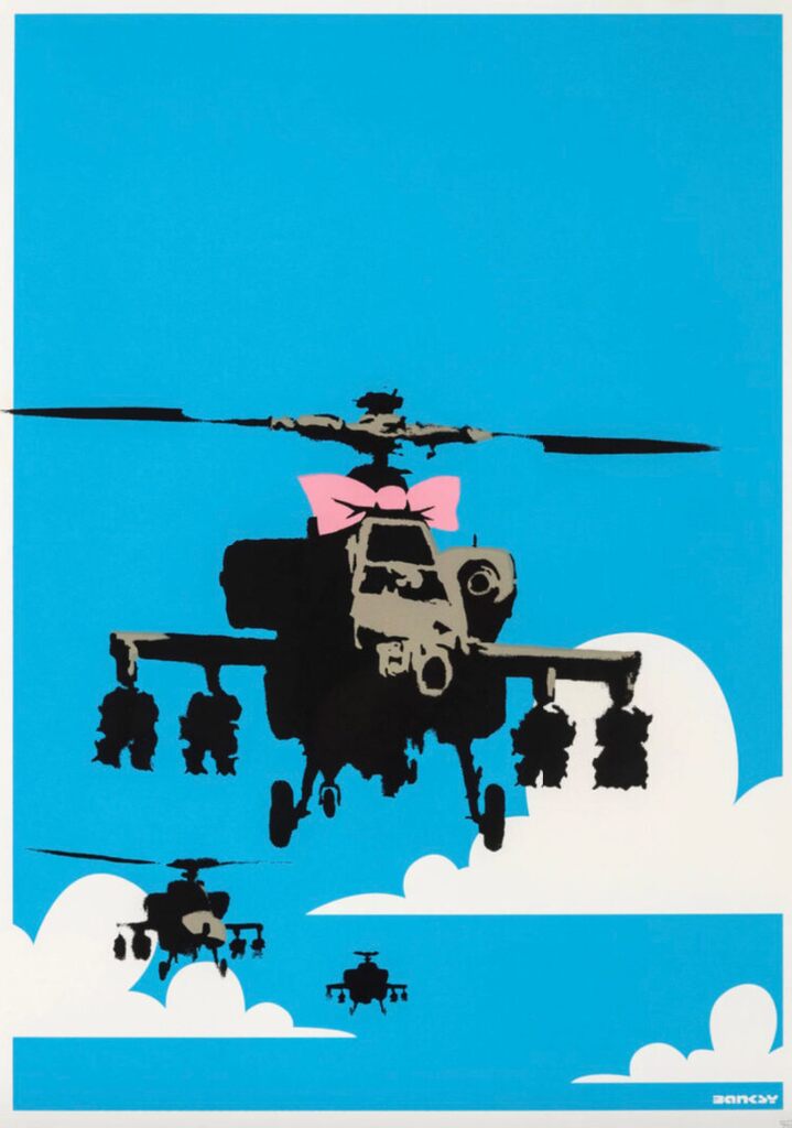 Three military helicopters appear among white clouds against bright blue; the large foreground helicopter has a pink bow above its cockpit.