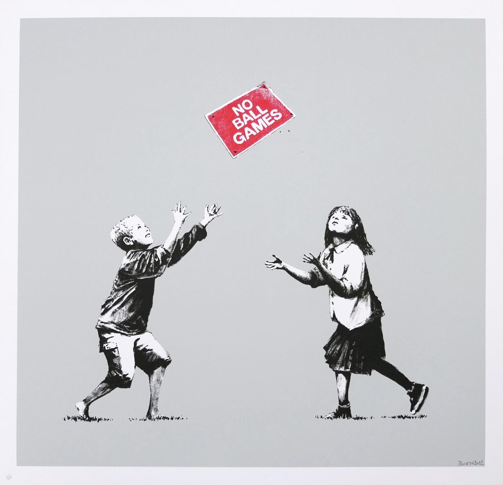 Two children tossing a red 'No ball games' sign against gray.