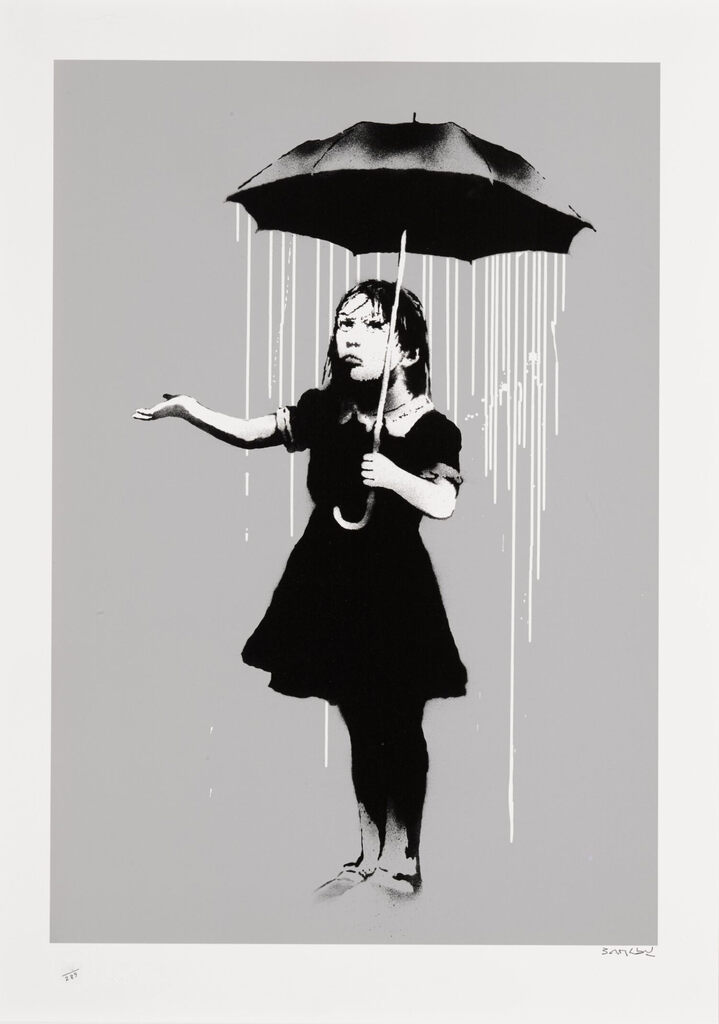 A girl holds a black umbrella with rain falling from beneath it, extending her other hand beyond its edge, palm upwards.