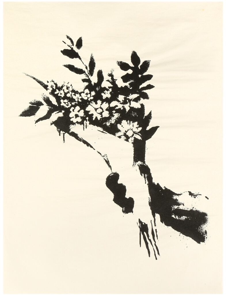 Black and white hand grasping a leafy bouquet against cream.