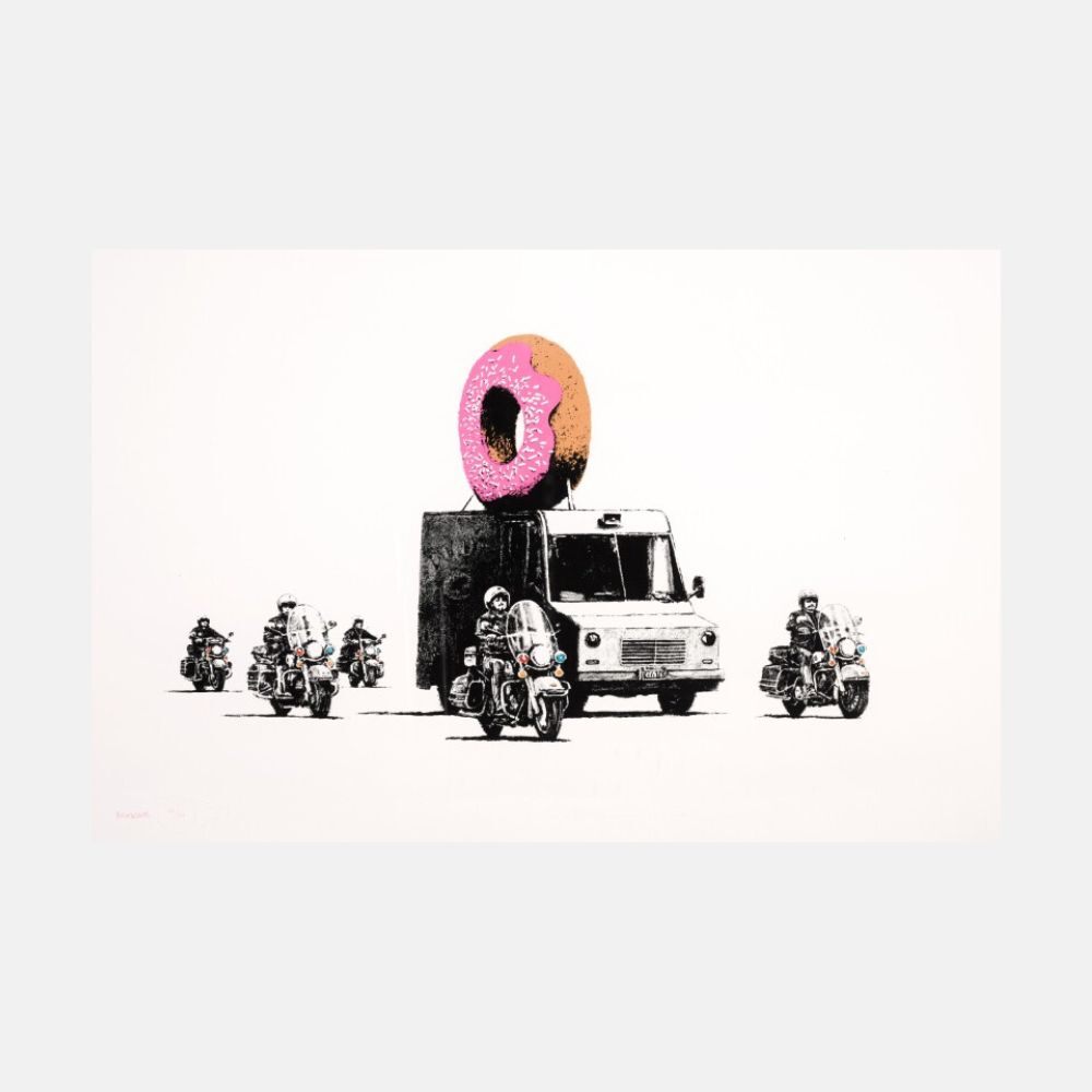 A large donut with pink frosting, white sprinkles and a brown half sits above a boxy van, with motorcyclists and their black-and-white motorcycles arranged around it.