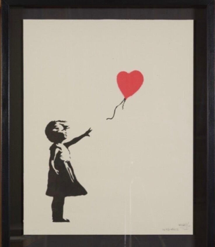 Dark-framed girl reaching toward a red heart balloon.