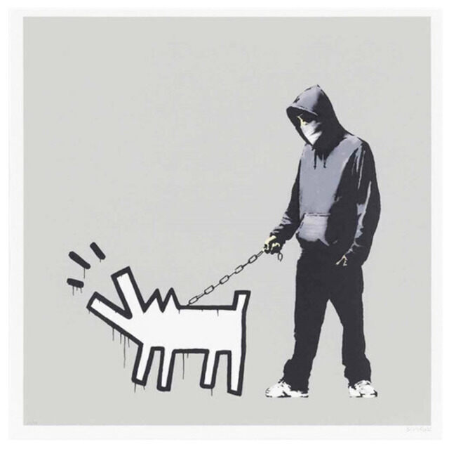 A hooded, masked figure in dark clothes and white trainers holds a chain leash attached to a white, black-outlined Haring-style barking dog with radiating lines on a silver-grey ground.