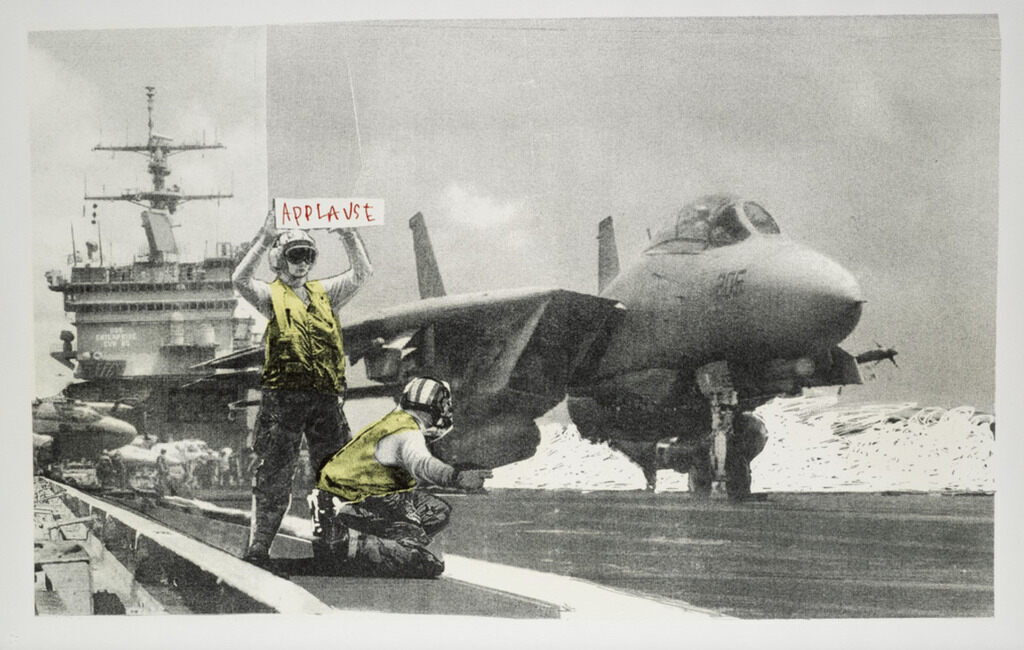 A monochrome jet on an aircraft-carrier deck with yellow-accented figures nearby.