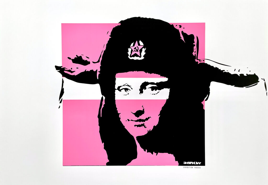 A woman’s face wearing a large black fur hat appears against bright pink.