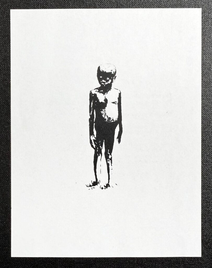 A small dark standing child figure centred on a large white sheet.